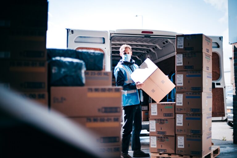 delivery worker loading a truck with boxes