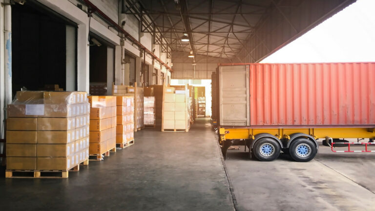 a warehouse and a truck being loaded with boxes
